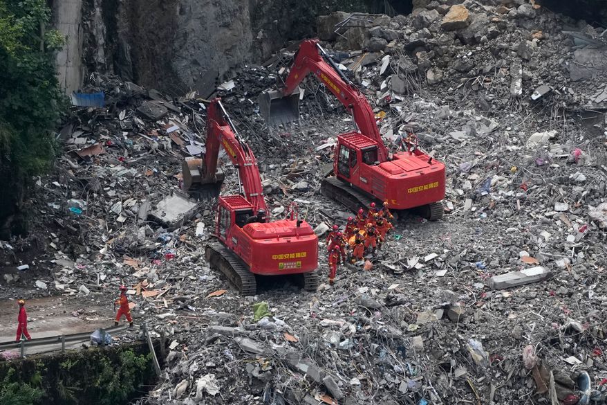 Rescuers work at the site of a landslide in Pengshui County in southwestern China's Chongqing on Sunday, July 19, 2026. (AP Photo/Andy Wong)
