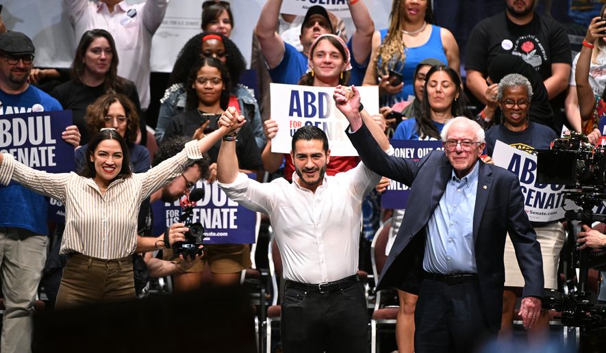 From left foreground, U.S. Rep. Alexandria Ocasio-Cortez, D-N.Y., Michigan Democratic U.S. Senate primary candidate Abdul El-Sayed, and U.S. Sen. Bernie Sanders, I-VT. join hands together following a campaign rally, Saturday, July 18, 2026, in Detroit. (AP Photo/Jose Juarez)