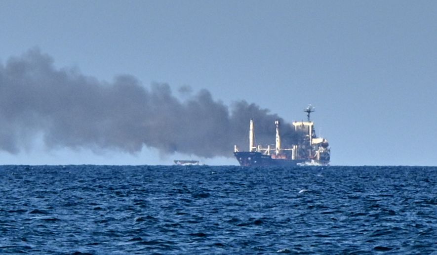 Smoke rises from the grain carrier Golden Leo under the Guinea-Bissau flag after Russian missile strike in the Black Sea close to Odesa, Ukraine, Sunday, July 19, 2026, local media reports. (AP Photo/Michael Shtekel)