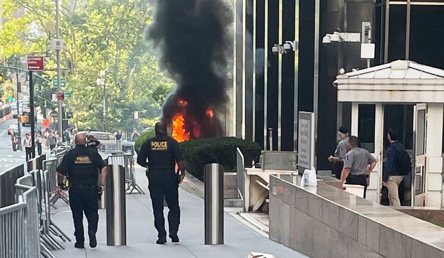 This photo provided by Robert Sullivan shows black smoke and flames in front of 26 Federal Plaza in lower Manhattan, Monday, July 20, 2026, in New York. (Robert Sullivan via AP)