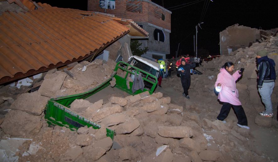 Residents walk amid the debris of homes that collapsed after an earthquake struck Pumpuya, Peru, Sunday, July 19, 2026. A magnitude 6.7 earthquake shook Peru's southern Andes Mountains on Thursday, Aug. 20, 2026, according to the U.S. Geological Survey. There were no immediate reports of damage. ( AP Photo/Javier Ninanya)