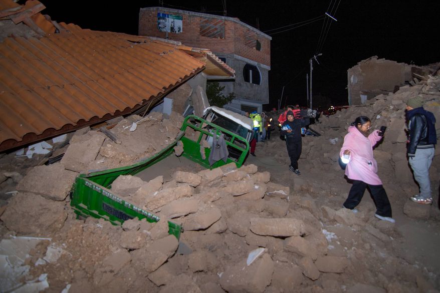 Residents walk amid the debris of homes that collapsed after an earthquake struck Pumpuya, Peru, Sunday, July 19, 2026. A magnitude 6.7 earthquake shook Peru's southern Andes Mountains on Thursday, Aug. 20, 2026, according to the U.S. Geological Survey. There were no immediate reports of damage. ( AP Photo/Javier Ninanya)