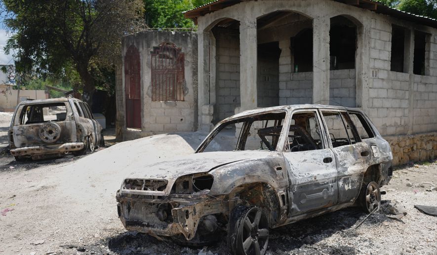 FILE - Vehicles that were set on fire by armed gangs sit in the Cite Soleil neighborhood of Port-au-Prince, Haiti, May 12, 2026. (AP Photo/Odelyn Joseph, File)