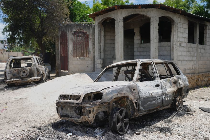FILE - Vehicles that were set on fire by armed gangs sit in the Cite Soleil neighborhood of Port-au-Prince, Haiti, May 12, 2026. (AP Photo/Odelyn Joseph, File)