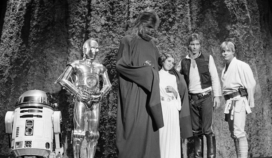 Kenny Baker, from left, Anthony Daniels, Peter Mayhew, Carrie Fisher, Harrison Ford and Mark Hamill are seen during the filming of the CBS-TV special, "The Star Wars Holiday," in Los Angeles, Nov. 13, 1978. (AP Photo/George Brich, File)