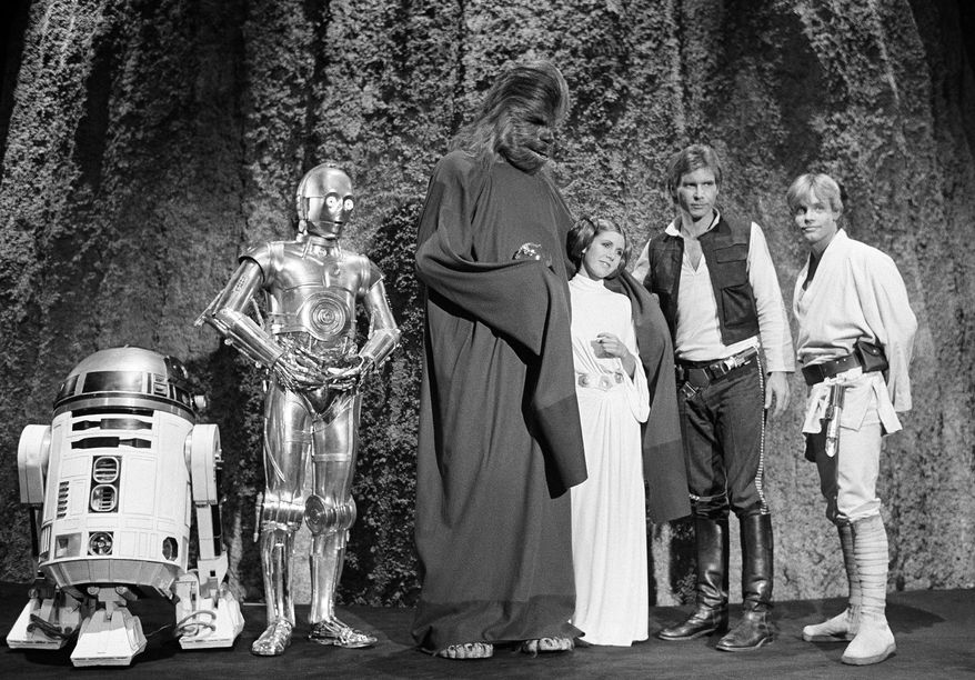 Kenny Baker, from left, Anthony Daniels, Peter Mayhew, Carrie Fisher, Harrison Ford and Mark Hamill are seen during the filming of the CBS-TV special, "The Star Wars Holiday," in Los Angeles, Nov. 13, 1978. (AP Photo/George Brich, File)