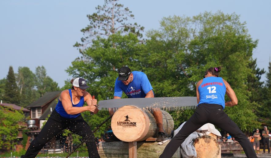 Kate Witkowski, left, and Erin Lavoie compete in the Jill and Jill event during the Lumberjack World Championships, Saturday, July 18, 2026, in Hayward, Wis. (AP Photo/Ellen Schmidt)