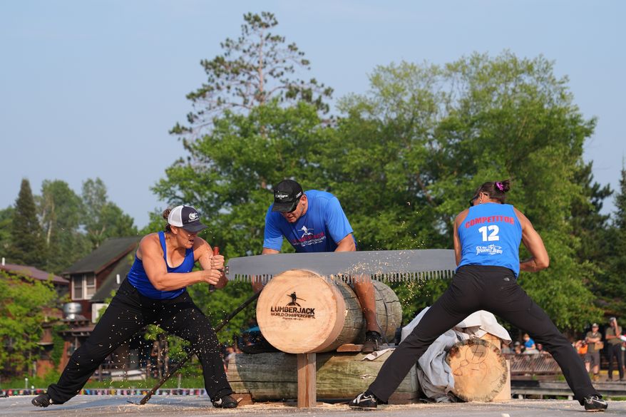 Kate Witkowski, left, and Erin Lavoie compete in the Jill and Jill event during the Lumberjack World Championships, Saturday, July 18, 2026, in Hayward, Wis. (AP Photo/Ellen Schmidt)