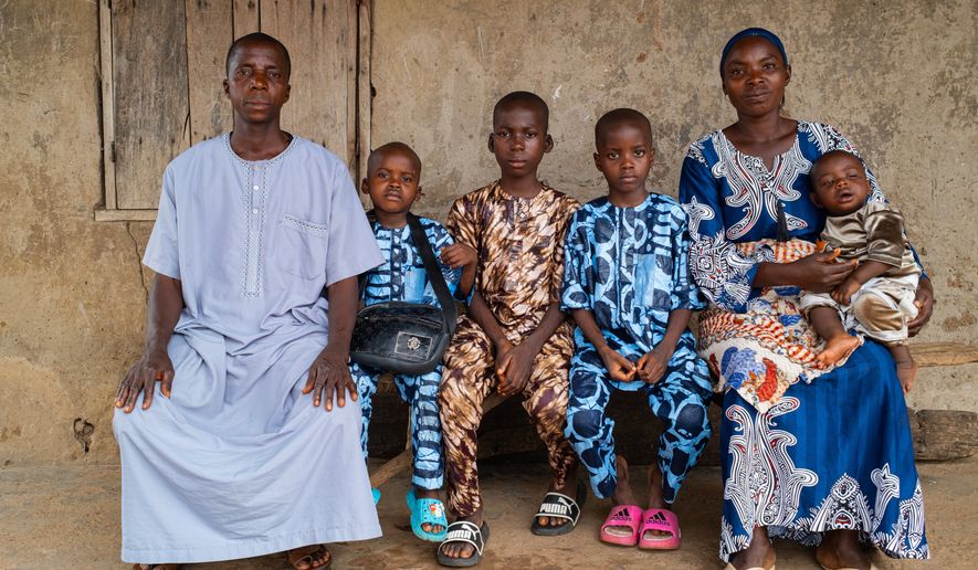 Aliyu Saheed and his wife pose for a photograph with his children that were released after being kidnapped with others from a school by al-Qaida-linked fighters in Esinele, Southwestern, Nigeria, July 17, 2026. (AP Photo/Pelumi Salako)