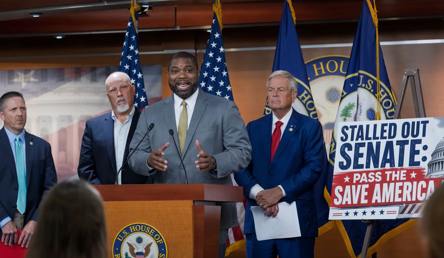 Rep. Byron Donalds, R-Fla., center, flanked by Rep. Chip Roy, R-Texas, left, and Rep. Ralph Norman, R-S.C., right, speaks to reporters as the conservative House Freedom Caucus slams the Senate for not acting on the Save America Act at the Capitol in Washington, Thursday, June 25, 2026. (AP Photo/J. Scott Applewhite) ** FILE **