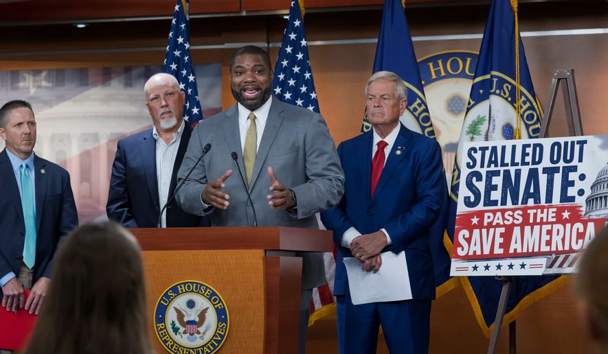 Rep. Byron Donalds, R-Fla., center, flanked by Rep. Chip Roy, R-Texas, left, and Rep. Ralph Norman, R-S.C., right, speaks to reporters as the conservative House Freedom Caucus slams the Senate for not acting on the Save America Act at the Capitol in Washington, Thursday, June 25, 2026. (AP Photo/J. Scott Applewhite)