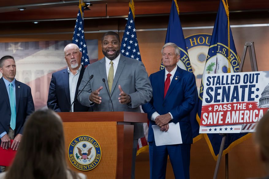 Rep. Byron Donalds, R-Fla., center, flanked by Rep. Chip Roy, R-Texas, left, and Rep. Ralph Norman, R-S.C., right, speaks to reporters as the conservative House Freedom Caucus slams the Senate for not acting on the Save America Act at the Capitol in Washington, Thursday, June 25, 2026. (AP Photo/J. Scott Applewhite)