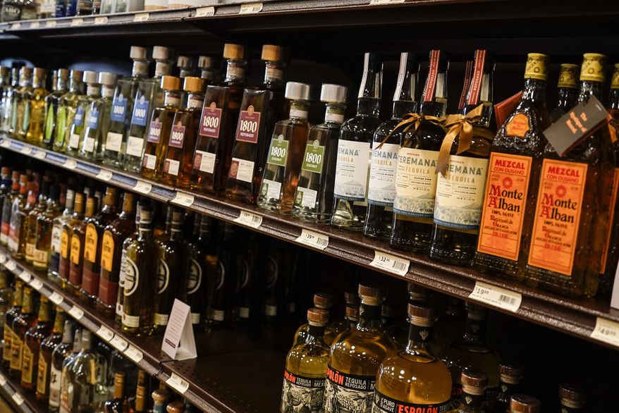 Shelves display bottles of tequila for sale at a Pennsylvania fine wine and spirits store, Saturday, Jan. 22, 2022, in Harmony, Pa. (AP Photo/Keith Srakocic)