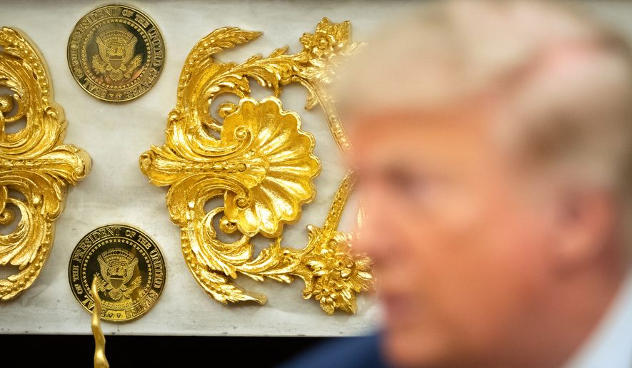 Gold-colored Presidential seals are seen on a fireplace in the Oval Office as President Donald Trump meets with Lebanese President Joseph Aoun at the White House, Tuesday, July 21, 2026, in Washington. (AP Photo/Mark Schiefelbein)