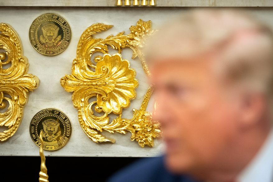 Gold-colored Presidential seals are seen on a fireplace in the Oval Office as President Donald Trump meets with Lebanese President Joseph Aoun at the White House, Tuesday, July 21, 2026, in Washington. (AP Photo/Mark Schiefelbein)