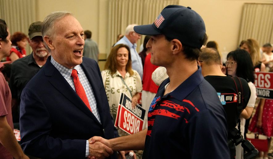 Rep. Andy Biggs, R-Ariz., who is running in the primary for Arizona governor, greets a supporter at a campaign event, Friday, July 17, 2026, in Gilbert, Ariz. (AP Photo/Ross D. Franklin)