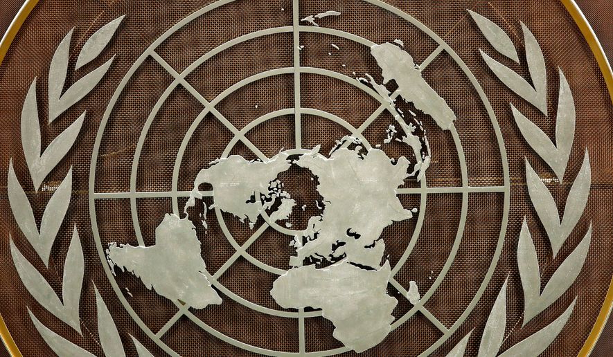 FILE - The United Nations logo is seen at the General Assembly hall at U.N. headquarters, Sept. 21, 2021. (Eduardo Munoz/Pool Photo via AP, file)
