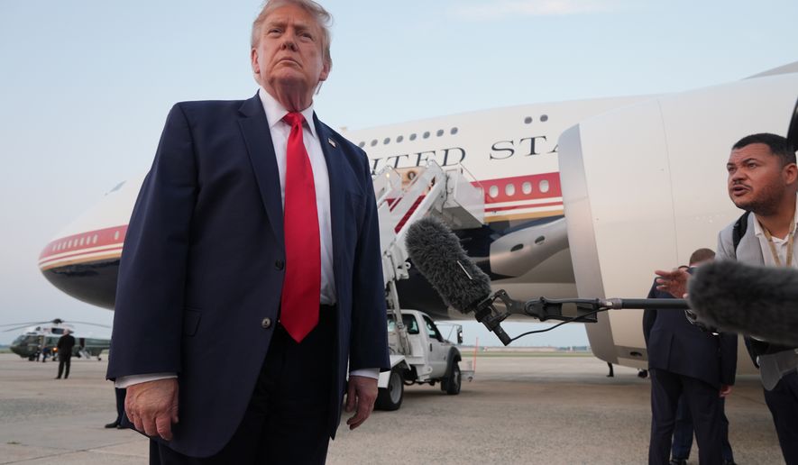 President Donald Trump speaks to reporters as he exits Air Force One at Joint Base Andrews, Md., after attending the World Cup final soccer match, Sunday, July 19, 2026. (AP Photo/Jacquelyn Martin)