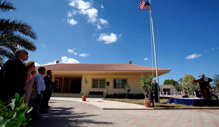 FILE - U.S. Ambassador to Libya Gene A. Cretz, right, stands at the podium during a flag raising ceremony for the U.S. Embassy in Tripoli, Libya, Sept. 22, 2011. (AP Photo Abdel Magid al-Fargany, File)