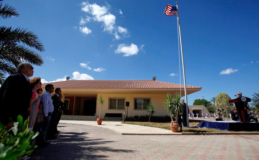 FILE - U.S. Ambassador to Libya Gene A. Cretz, right, stands at the podium during a flag raising ceremony for the U.S. Embassy in Tripoli, Libya, Sept. 22, 2011. (AP Photo Abdel Magid al-Fargany, File)