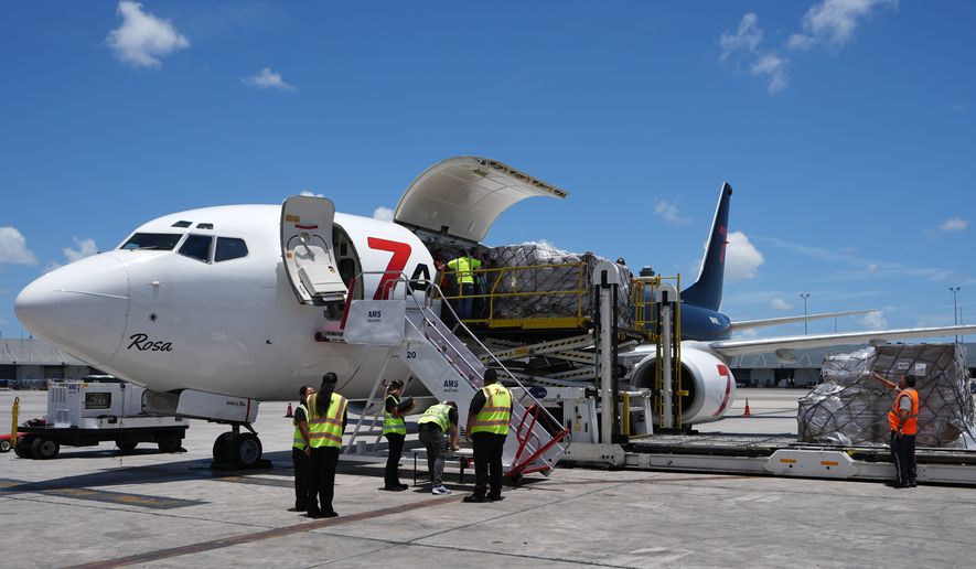People load pallets containing food and hygiene kits for a humanitarian assistance flight to Cuba organized by the Trump administration as the U.S. continues to put pressure on the island's government, Tuesday, July 21, 2026, in Miami. (AP Photo/Lynne Sladky)