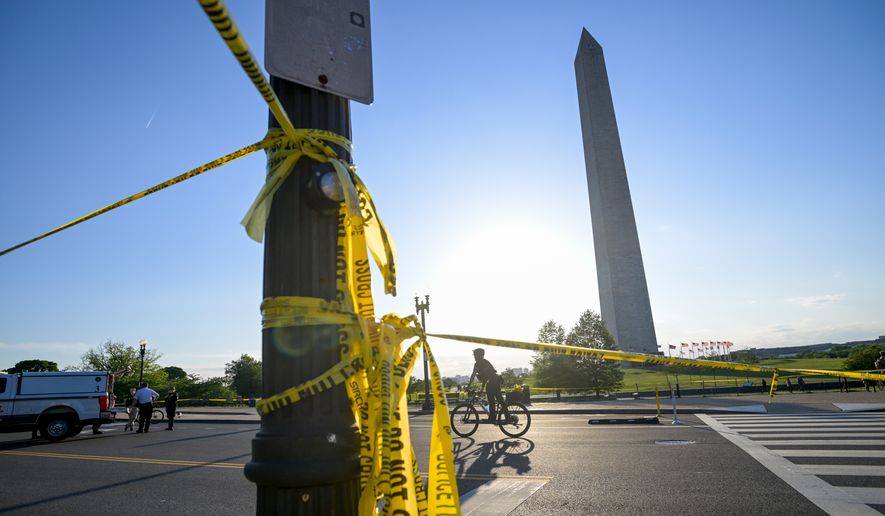 Police tape remains around the scene after a person was shot near the Washington Monument in May 4, 2026, in Washington. (AP Photo/Rod Lamkey Jr., File)