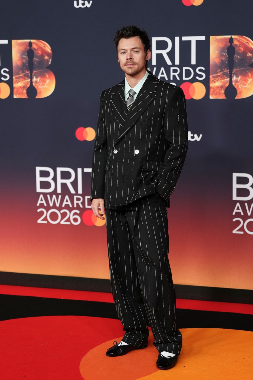 Harry Styles poses for photographers upon arrival at the Brit Awards 2026 in Manchester, England, Saturday, Feb. 28, 2026. (Photo by Scott A Garfitt/Invision/AP)