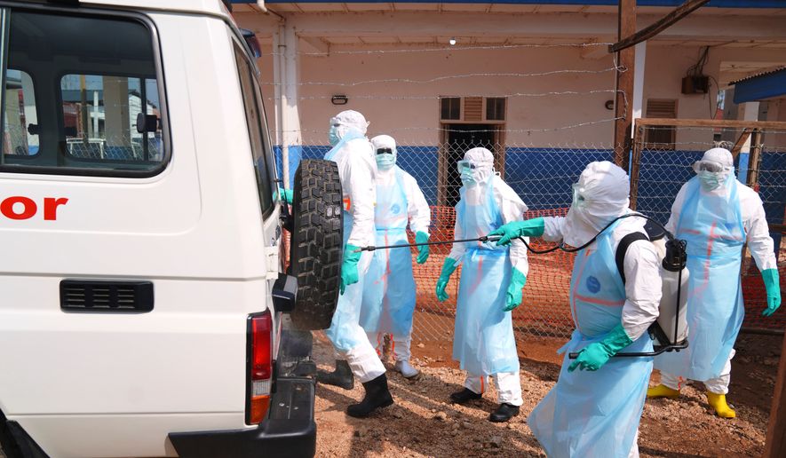 Health workers disinfects an ambulance at Ebola Treatment Center at Bunia General Hospital in Ituri, Congo, Wednesday, July 22, 2026. (AP Photo/Dirole Lotsima Dieudonne) ** FILE **