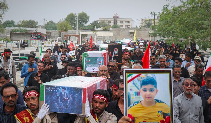 Mourners carry the coffins containing additional remains of victims identified through DNA testing during funeral ceremonies in Minab, Iran, Tuesday, July 22, 2026, nearly five months after they were killed in the Feb. 28 strike on the Shajareh Tayyebeh School.(Razieh Poudat/ISNA via AP)