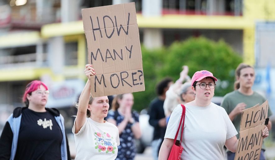 Protesters march after a Madison police officer shot and killed a man Wednesday, July 22, 2026, in Madison, Wis. (AP Photo/Kayla Wolf)