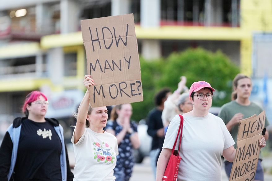 Protesters march after a Madison police officer shot and killed a man Wednesday, July 22, 2026, in Madison, Wis. (AP Photo/Kayla Wolf)