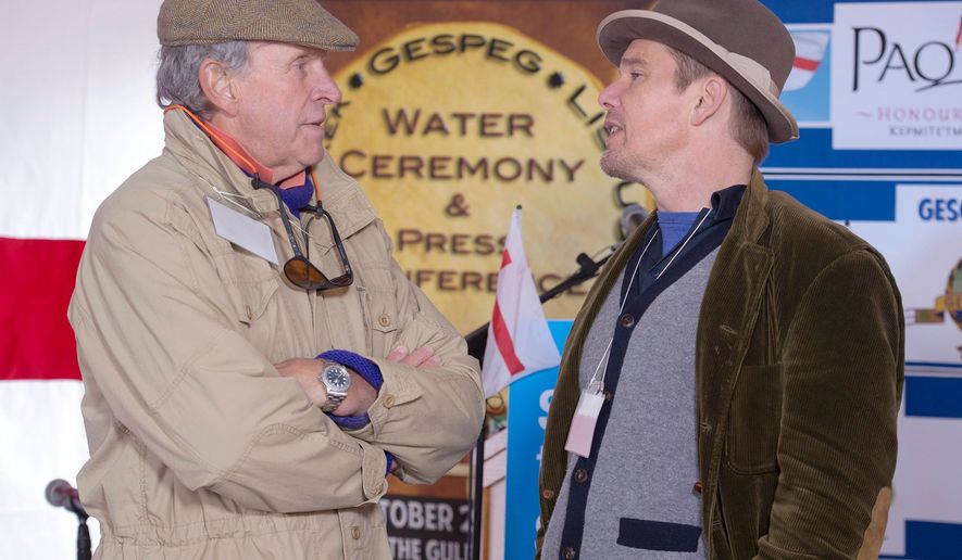 FILE - Actor Ethan Hawke, right, talks with Charles Gaines as they attend the Mi'kmaq community's water ceremony on the shores of Pomquet Harbour to support the aboriginal call for a moratorium on oil and gas exploration in the Gulf of St. Lawrence, near Antigonish, Nova Scotia, on Oct. 26, 2015. (Andrew Vaughan/The Canadian Press via AP)