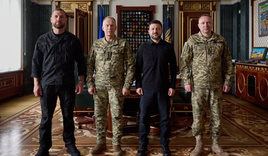 In this photo provided by the Ukrainian Presidential Press Office, from left, acting Minister of Defense Major General Yevhen Khmara, former Commander-in-Chief of the Ukrainian Armed Forces Oleksandr Syrskyi, Ukrainian President Volodymyr Zelenskyy and new commander-in-chief of Ukraine's Armed Forces Mykhailo Drapatyi, pose for a photo during their meeting in Kyiv, Ukraine, Wednesday, July 22, 2026. (Ukrainian Presidential Press Office via AP)