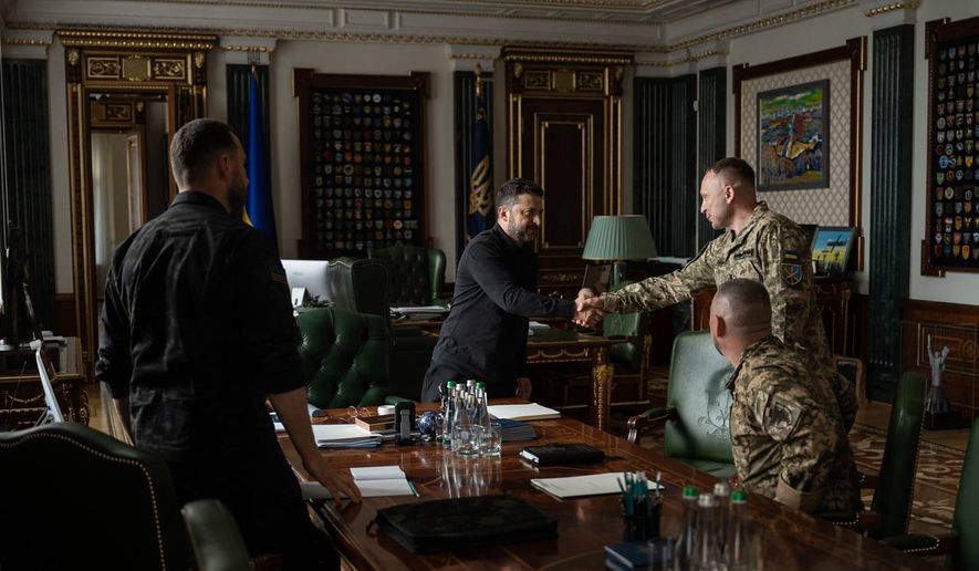 In this photo provided by the Ukrainian Presidential Press Office, Ukrainian President Volodymyr Zelenskyy, center, shakes hands with the new commander-in-chief of Ukraine's Armed Forces, Mykhailo Drapatyi, during their meeting in Kyiv, Ukraine, Monday, July 20, 2026. (Ukrainian Presidential Press Office via AP) ** FILE **