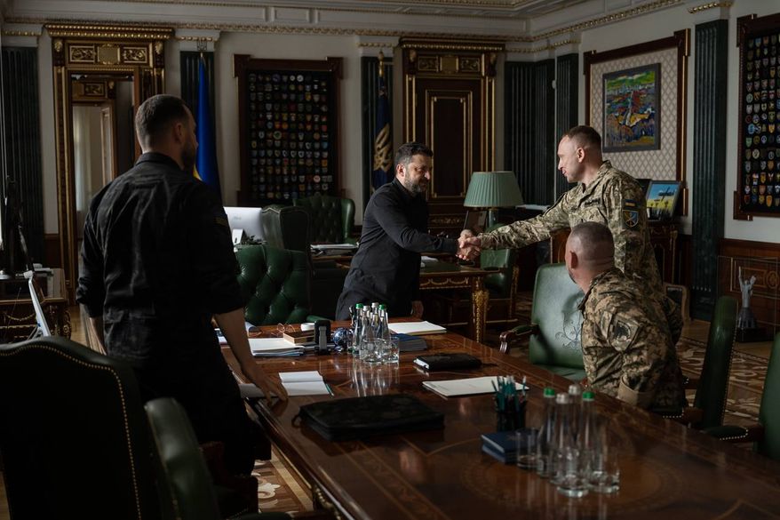 In this photo provided by the Ukrainian Presidential Press Office, Ukrainian President Volodymyr Zelenskyy, center, shakes hands with the new commander-in-chief of Ukraine's Armed Forces, Mykhailo Drapatyi, during their meeting in Kyiv, Ukraine, Monday, July 20, 2026. (Ukrainian Presidential Press Office via AP) ** FILE **