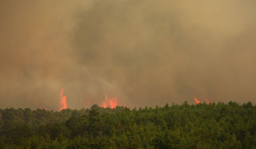 Wildfire advances near Condemios de Arriba, Guadalajara province, Spain, Wednesday, July 22, 2026, after a wildfire scorched tens of thousands of hectares in one of Spain's largest wildfires in recent years. (AP Photo/Manu Fernandez)