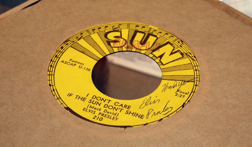 A 1954 Elvis Presley signed Sun Records 45rpm record of "I Don't Care If The Sun Don't Shine," estimated at $9,000 to $12,000, is displayed at Gotta Have It! Collectibles, in New York, Wednesday, July 19, 2017. (AP Photo/Richard Drew)