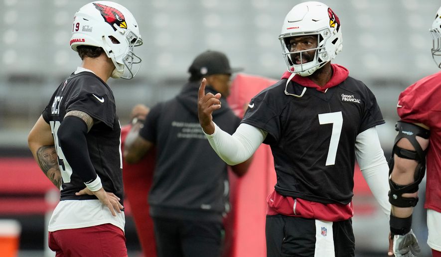 Arizona Cardinals quarterback Jacoby Brissett (7) talks with Cardinals quarterback Carson Beck, left, during NFL football training camp practice, Thursday, July 23, 2026, in Glendale, Ariz. (AP Photo/Ross D. Franklin)