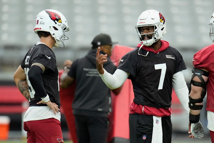Arizona Cardinals quarterback Jacoby Brissett (7) talks with Cardinals quarterback Carson Beck, left, during NFL football training camp practice, Thursday, July 23, 2026, in Glendale, Ariz. (AP Photo/Ross D. Franklin)