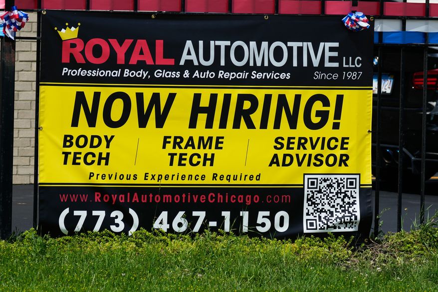 Now hiring sign is seen in front of an auto body shop in Chicago, Thursday, June 25, 2026. (AP Photo/Nam Y. Huh)