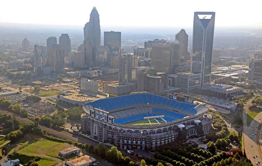 FILE - In this Aug. 16, 2012 file photo, the skyline of Charlotte, N.C., rises behind Bank of America Stadium in this aerial photo. (AP Photo/Chuck Burton, File)