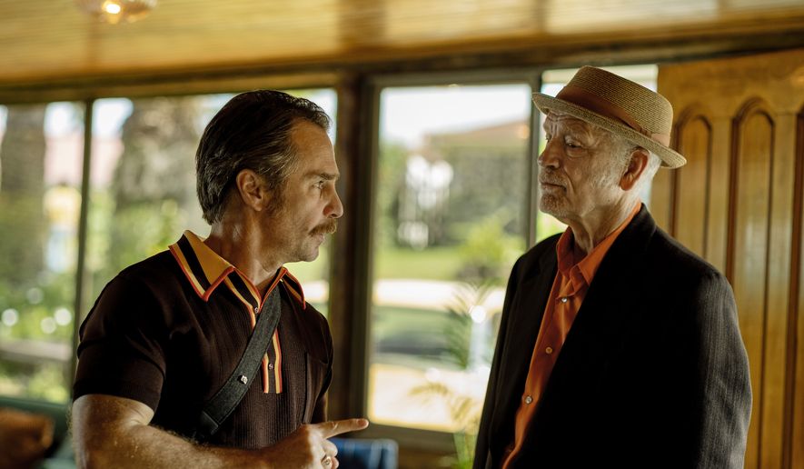 This image released by Searchlight Pictures shows Sam Rockwell, left, and John Malkovich in a scene from "Wild Horse Nine." (Diego Araya Corvalán/Searchlight Pictures via AP)