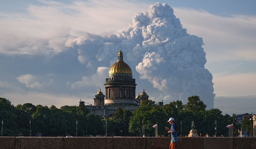 Smoke billows into the sky following Ukrainian drone strikes on warehouses of Russia's online retailer Wildberries, in St. Petersburg, Russia, Friday, July 24, 2026, with St. Isaac's Cathedral seen in foreground. (UGC via AP)