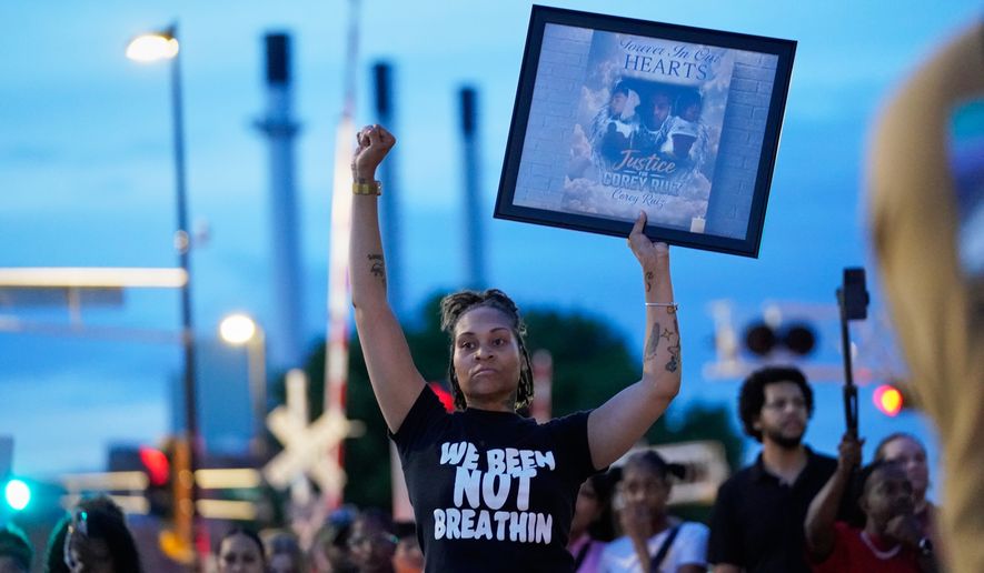 A protester holds a photo of Corey Durell Ruiz as they march Thursday, July 23, 2026, in Madison, Wis., after he was shot and killed by a Madison police officer on Wednesday. (AP Photo/Kayla Wolf)
