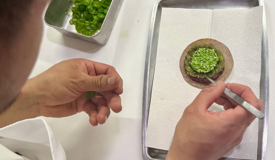 A tostada with bluefin tuna is prepared at Californios in San Francisco on Thursday, July 16, 2026. (AP Photo/Haven Daley)