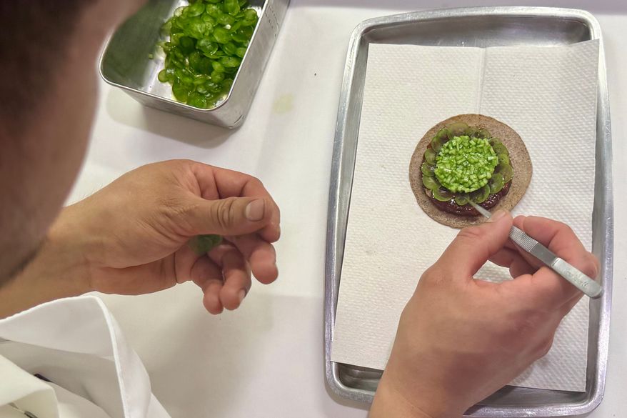 A tostada with bluefin tuna is prepared at Californios in San Francisco on Thursday, July 16, 2026. (AP Photo/Haven Daley)
