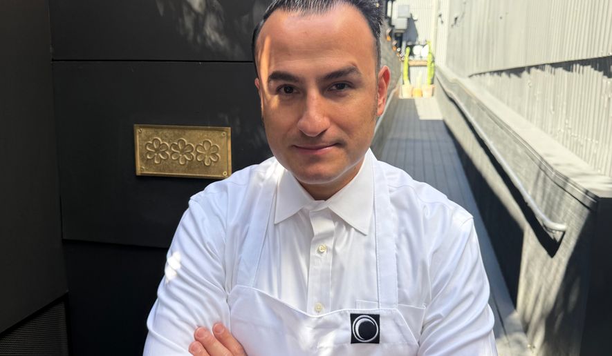 Chef Val Cantu, co-owner of Californios, poses in front of his three Michelin Star plaque in San Francisco on Thursday, July 16, 2026. (AP Photo/Haven Daley)