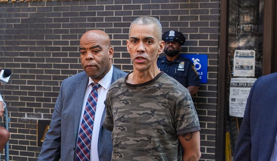 Raul Morales, a 51-year-old man who is accused of stabbing two people on the Upper West Side in Manhattan on Thursday afternoon is escorted out of the NYPD 20th Precinct by police officers in New York, Friday, July 24, 2026. (AP Photo/Ryan Murphy)