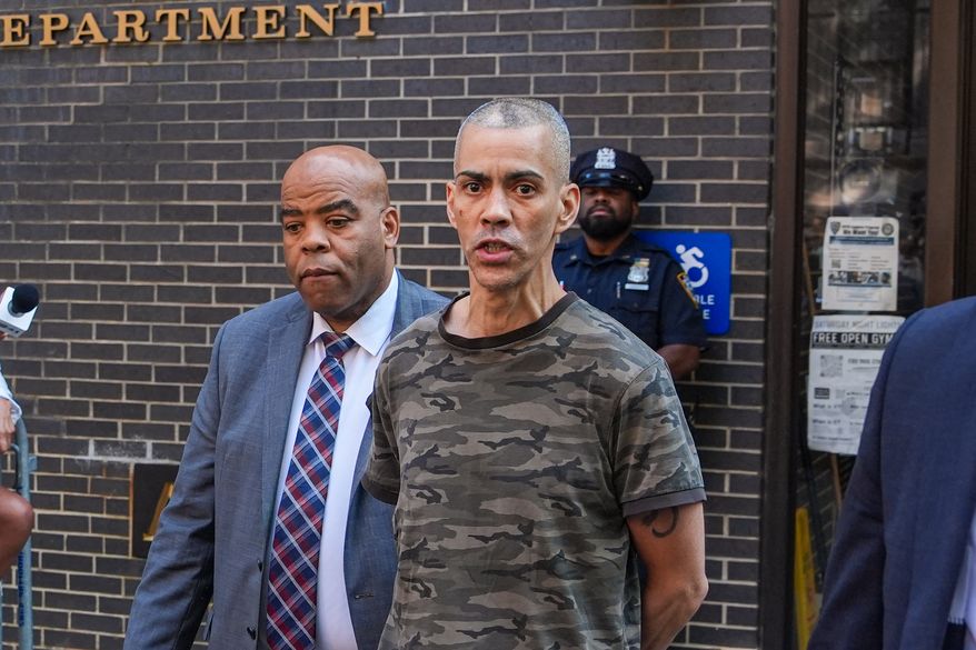 Raul Morales, a 51-year-old man who is accused of stabbing two people on the Upper West Side in Manhattan on Thursday afternoon is escorted out of the NYPD 20th Precinct by police officers in New York, Friday, July 24, 2026. (AP Photo/Ryan Murphy)