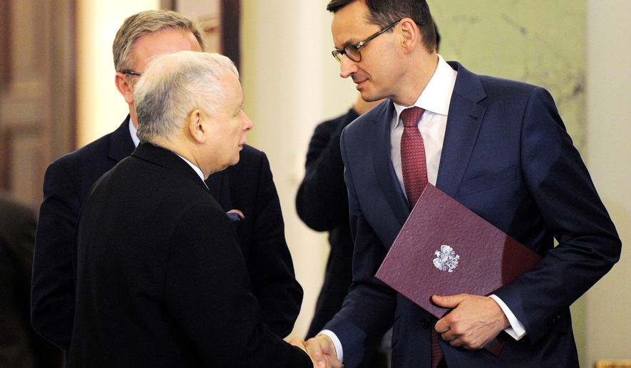 Newly designated for the prime minister's post Mateusz Morawiecki, right, is congratulated by Jaroslaw Kaczynski, left, leader of Poland's ruling conservative party Law and Justice, in Warsaw, Poland, Friday, Dec. 8, 2017. (AP Photo/Alik Keplicz, File)